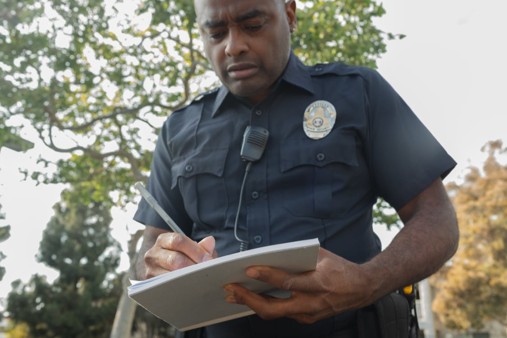 security officer writing details on a notepad 