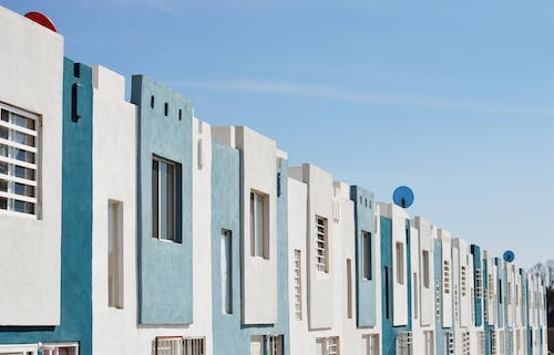 white and teal homes in a row