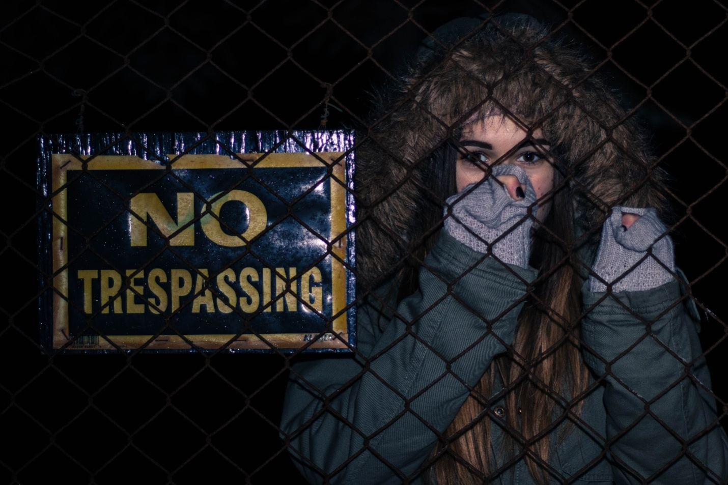 a woman with no trespassing signage