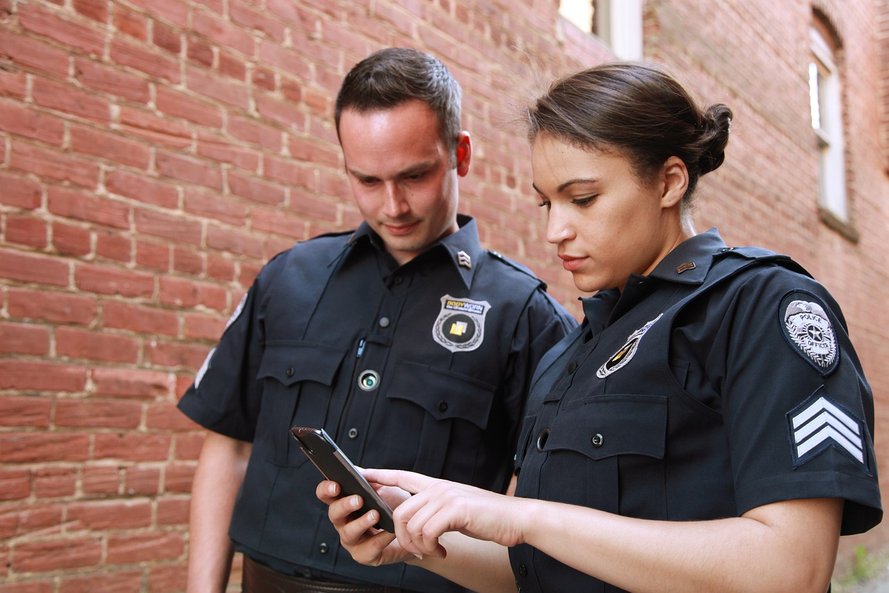 Two security officers looking at a phone