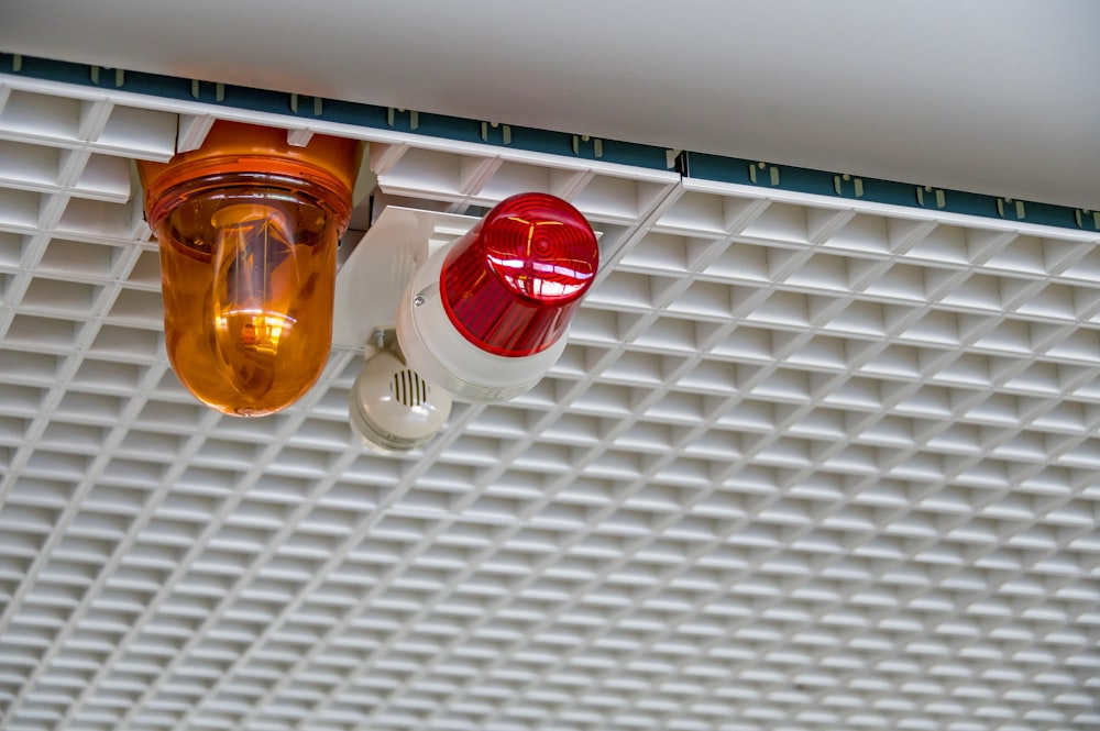 An alarm system with a red and orange light