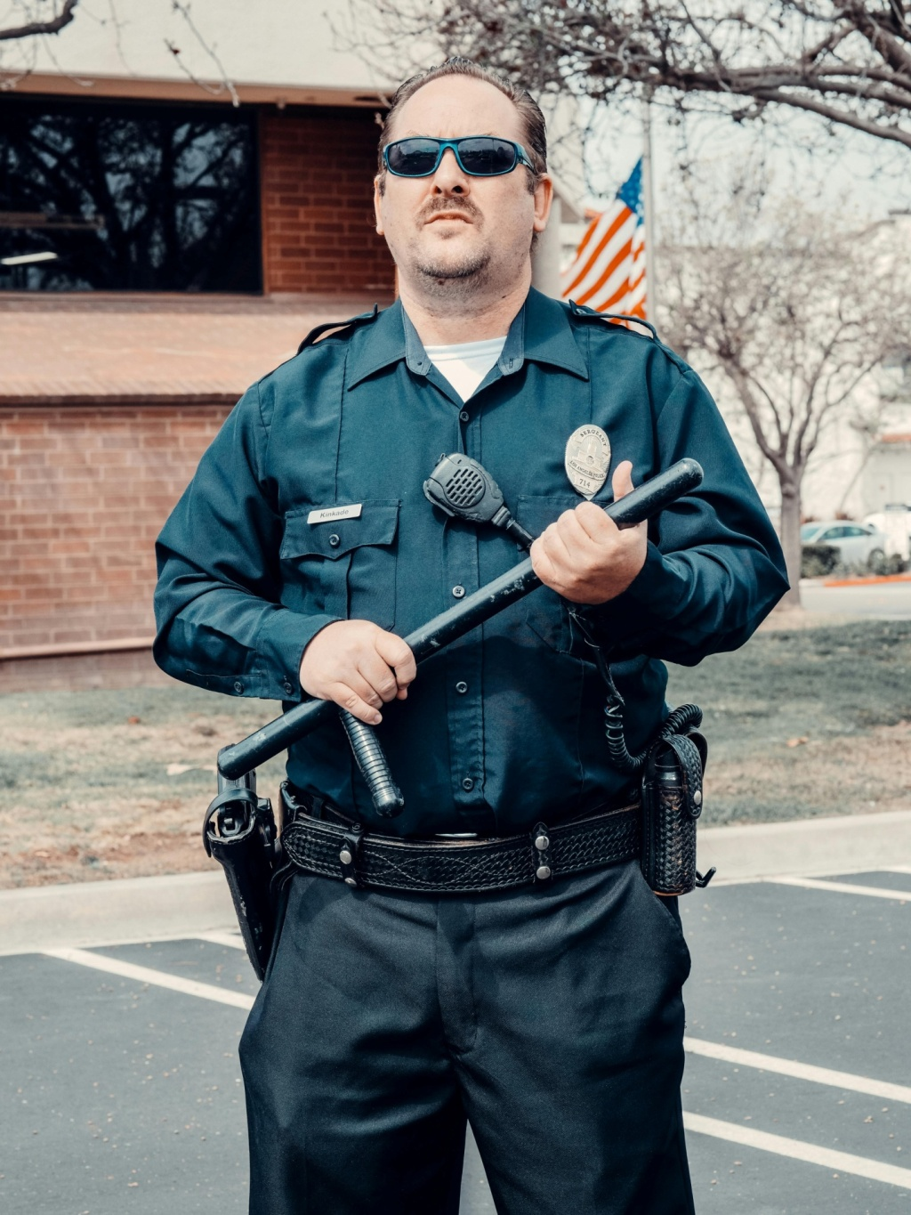 A security officer holding a baton