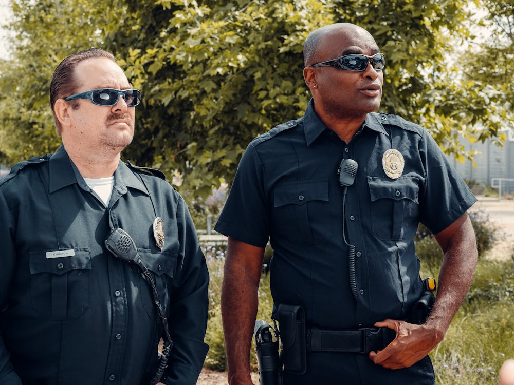  Two armed security professionals in black uniform