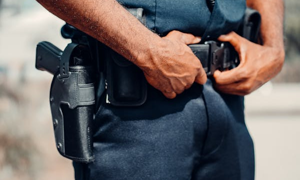 armed security official holding his belt