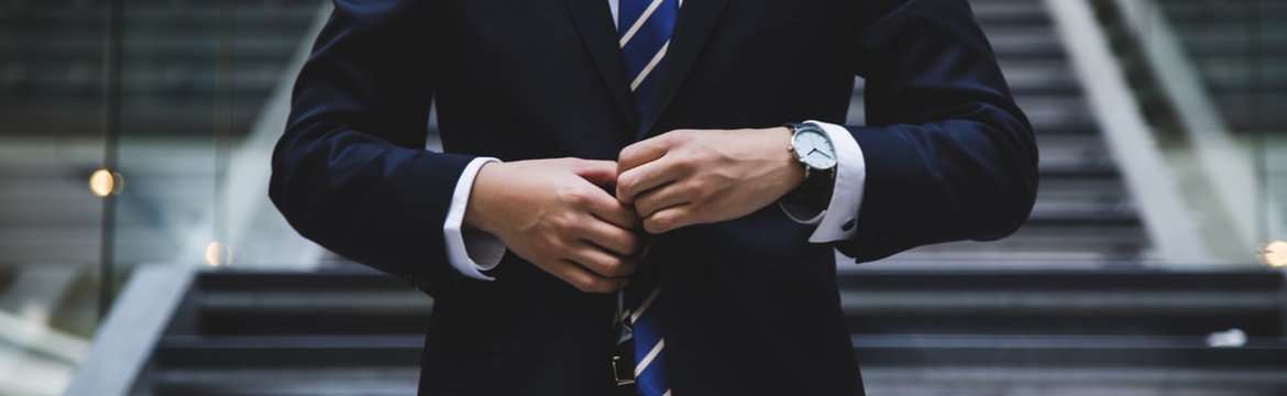 A security professional in a suit by https://unsplash.com/photos/MYbhN8KaaEc