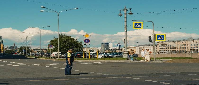 A traffic police standing in the middle of the street.