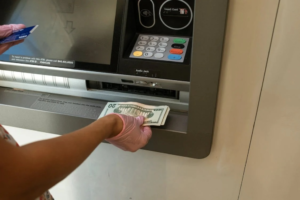 An image of a person withdrawing money from an ATM 