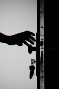 An image of a person reaching out for a doorknob  