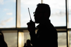 An image of a man using a walkie-talkie  