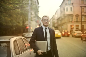 An image of a man holding a laptop