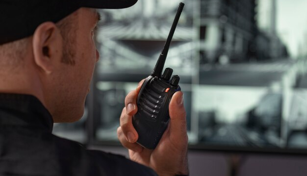 A security officer carefully reviewing multiple camera monitors for real-time surveillance.