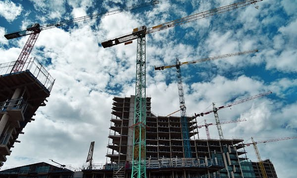Active construction site with cranes operating on a commercial project