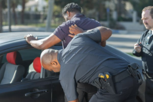 School security officer apprehending a man in a school setting to maintain safety and order