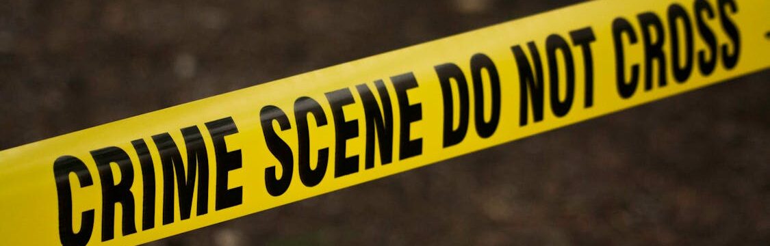 “Crime Scene Do Not Cross” yellow tape cordoning off an area